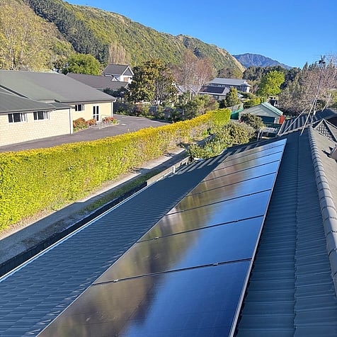 Solar array on a Raumati Beach home, tucked under the hills