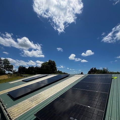 Solar panels on a big farm shed roof in Te Kowhai