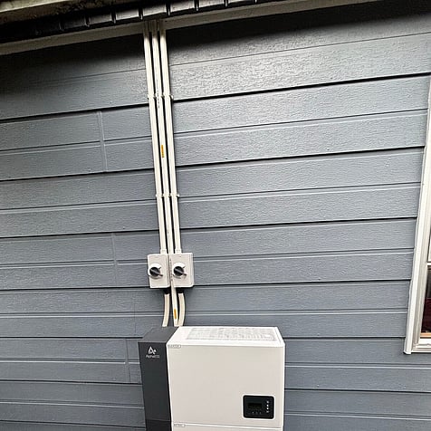 Compact home battery on an outside wall in Porirua