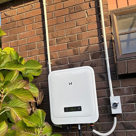 Solar inverter on a brick wall in Cambridge