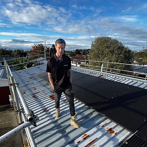 One of the crew on the roof during a Hamilton install