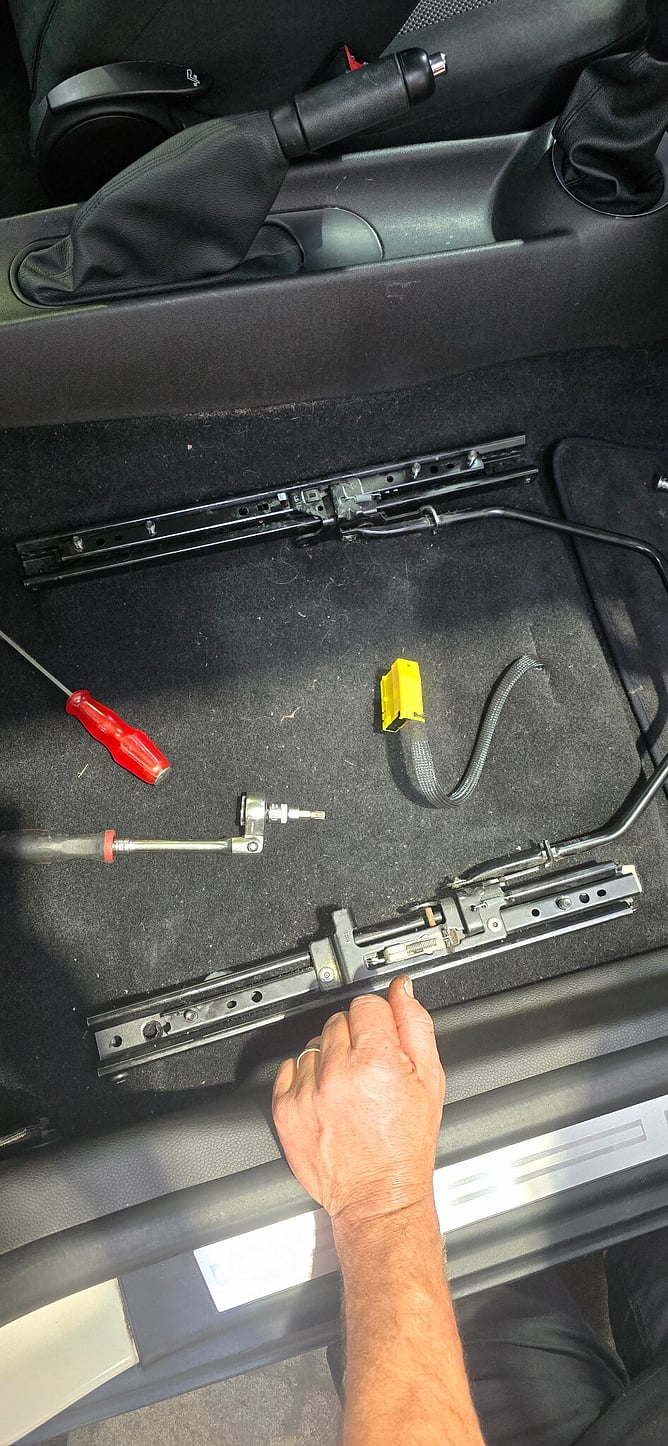 MINI seat rails and release mechanism exposed with the seat removed.