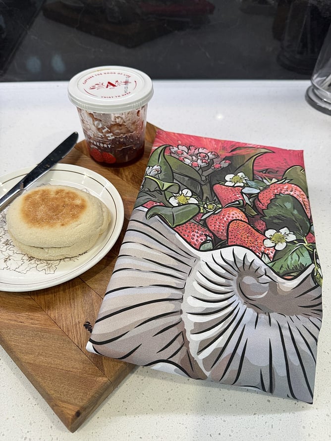 Strawberry Jam Crown Lynn Nautilus art print tea towel on a breadboard with jam and an English muffin