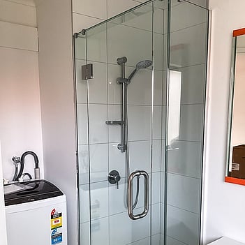 Completed shower install with a glass enclosure and chrome fixtures