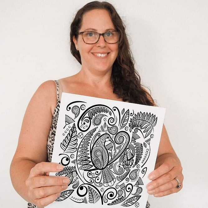 Anna Mollekin holding her original huia lace artwork, the design behind Huia&rsquo;s Lustrous Lacework pewter wall art