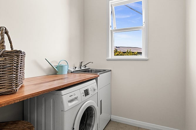 Renovated laundry with a new tub and timber bench