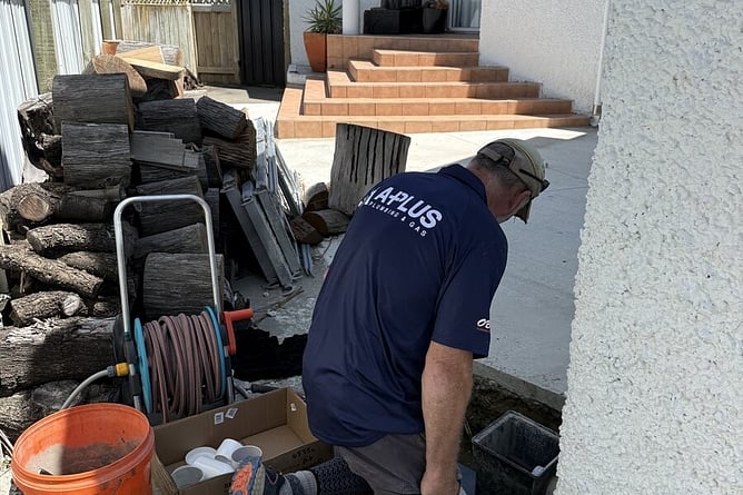 APlus plumber checking a drain access point beside a Hawke's Bay home