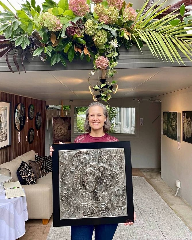 Ninette Kruger holding Huia&rsquo;s Lustrous Lacework, a 60 x 60cm one-of-a-kind pewter wall art piece