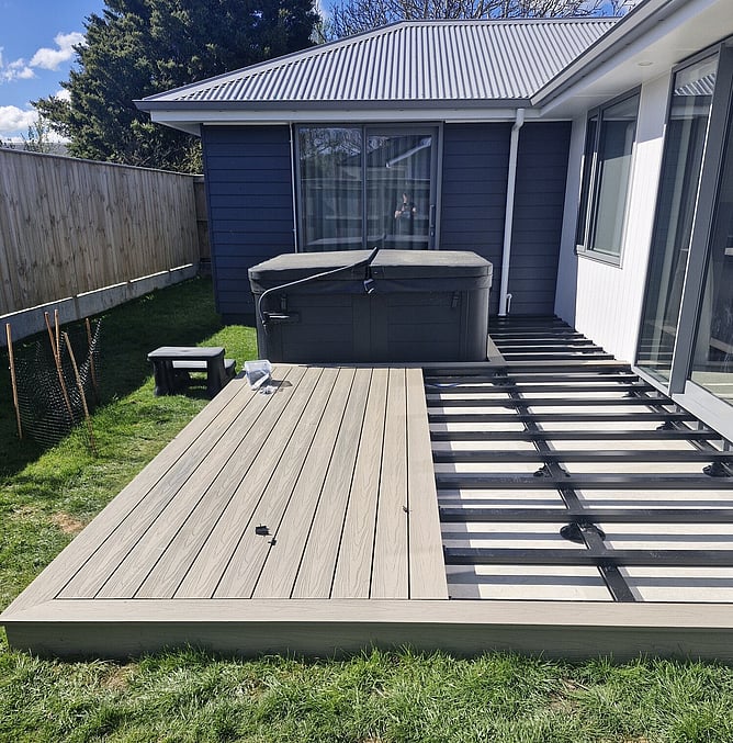 Decking boards meeting the edge of the spa pool cut-out on an aluminium-framed deck