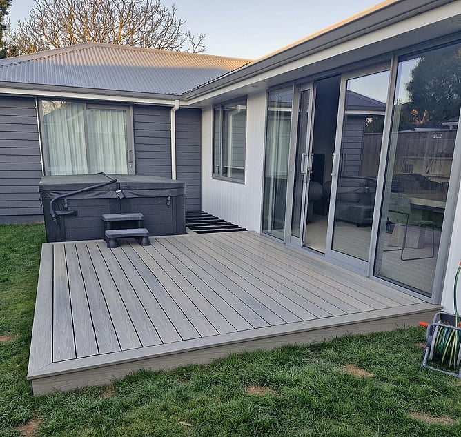 Finished timber deck wrapping around a spa pool in Palmerston North, built on TreadFrame aluminium framing