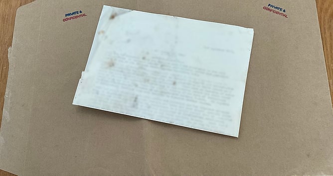 Old typed letter on a brown envelope marked Private and Confidential
