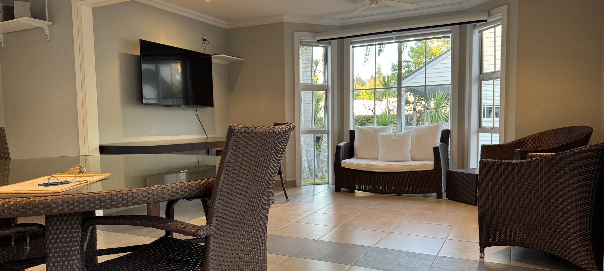 shared pool house social space with ice maker, large screen TV and dual BBQs for guest use