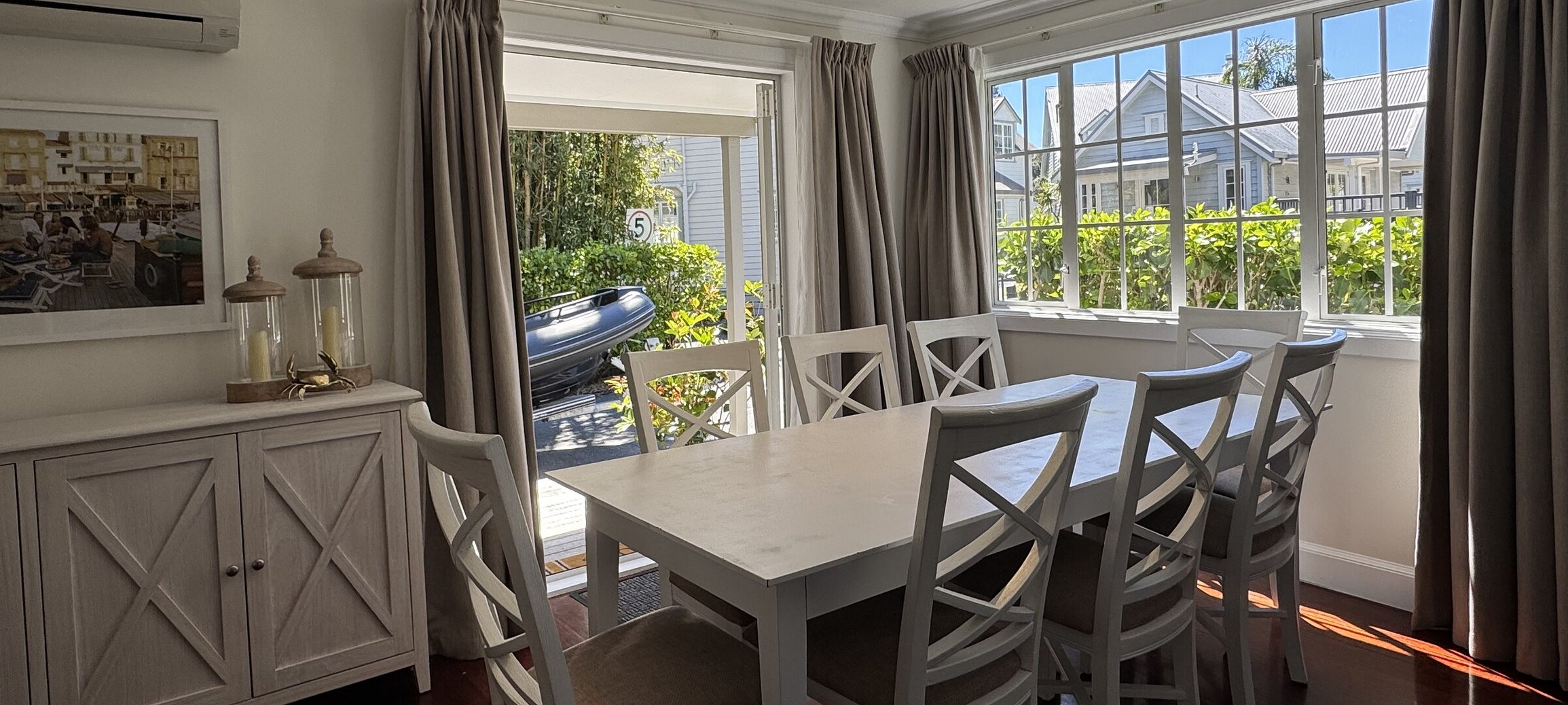 Spacious indoor dining area at Crab Shack Cottage in Russell featuring a large dining table set for 8 guests