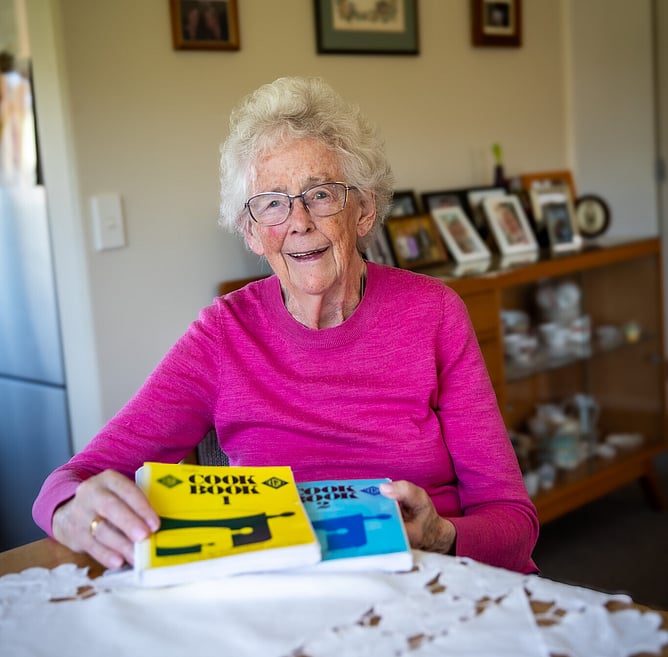 Catherine Birch at her home in Upper Hutt, with the two Rally cookbooks she developed.