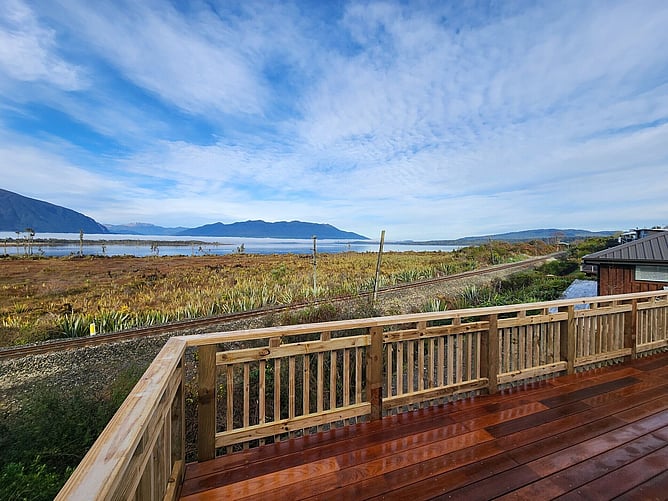 The view from the new deck across Lake Brunner to the mountains, with the railway line running below