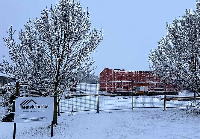 Snow on the timber framing and the Lifestyle Builds site sign during a Fairlie winter