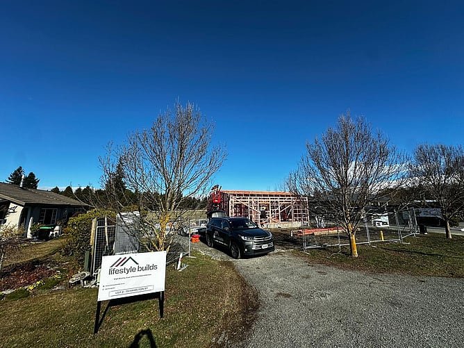 The Lifestyle Builds site sign at Lot 2, 19 Hamilton St, with the framing going up behind