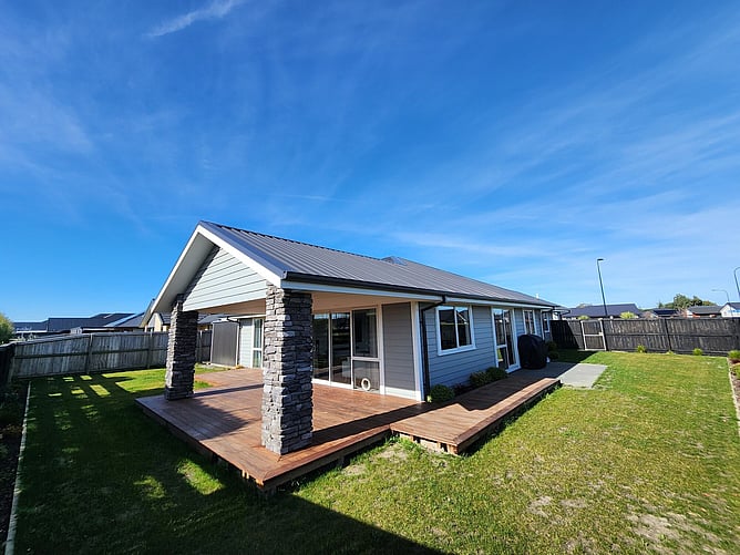 The back of the Rolleston showhome: Linear cladding, schist columns carrying the gable and Kwila decking off the living area