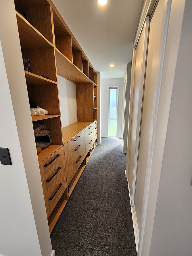 Built-in timber shelving and drawers along the hallway of the Rolleston showhome