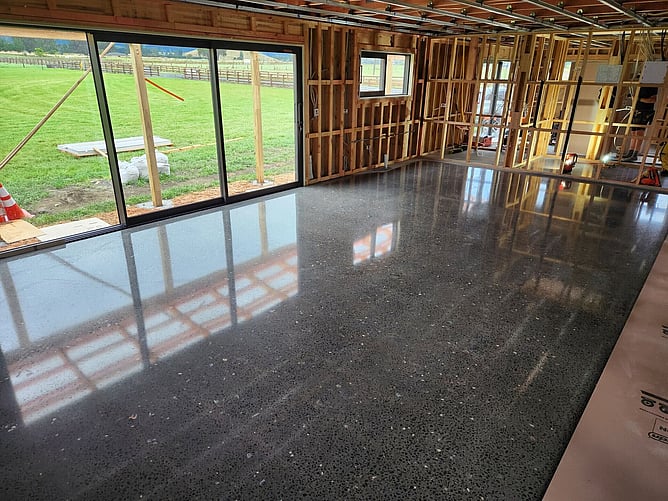 The polished concrete floor done before the walls were lined, with the slider looking out over the paddocks