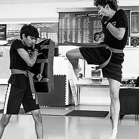 White belt kickboxer doing a turning kick