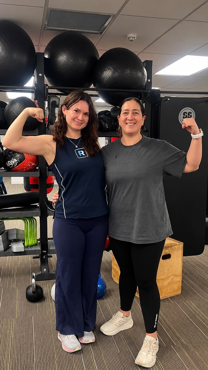 Suzie and her trainer Danyelle flexing together at The Right Fit Personal Training studio