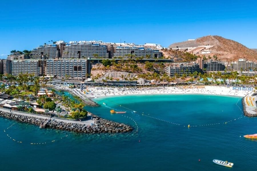 Sheltered white sand beach and resort hotels on the south coast of Gran Canaria