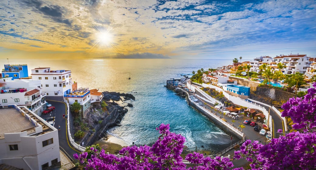 Seaside town with bougainvillea and a rocky cove on the coast of Tenerife, Canary Islands