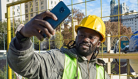 Tradie on site taking a photo of a job on their phone