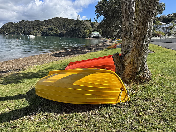 A yellow rowing boat on the beach along The Strand at the historic Russell waterfront, a flat 300-metre stroll from Crab Shack Cottage
