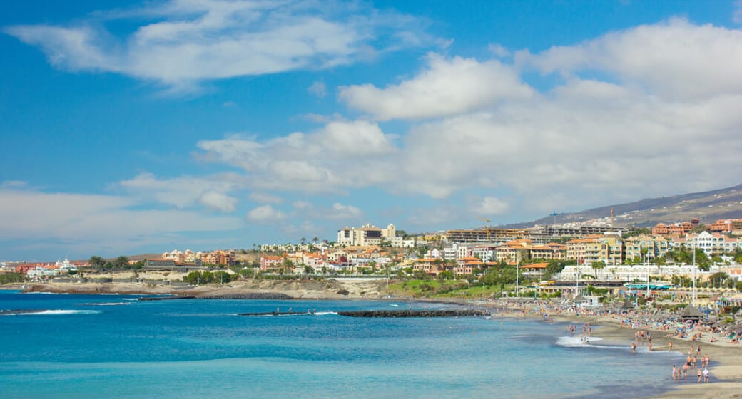 Sandy beach, breakwaters and seafront hotels on Tenerife's south-west coast near Playa de las Américas